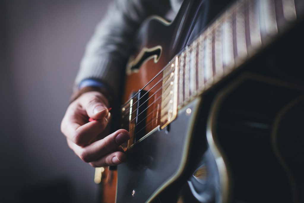 Playing guitar - side shot - free stock photo