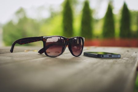 Sunglasses and phone on the table - free stock photo