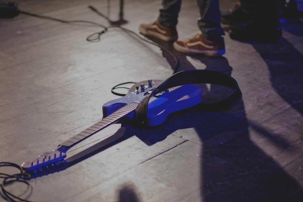 Guitar laying on the stage - free stock photo