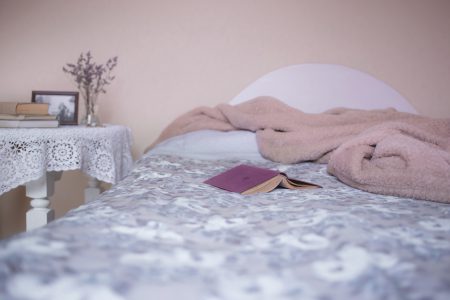 Open book on a bed - free stock photo