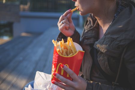 Girl eating french fries - free stock photo