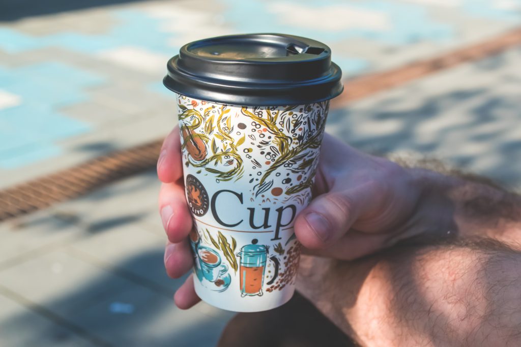 Hand holding cup of coffee - free stock photo