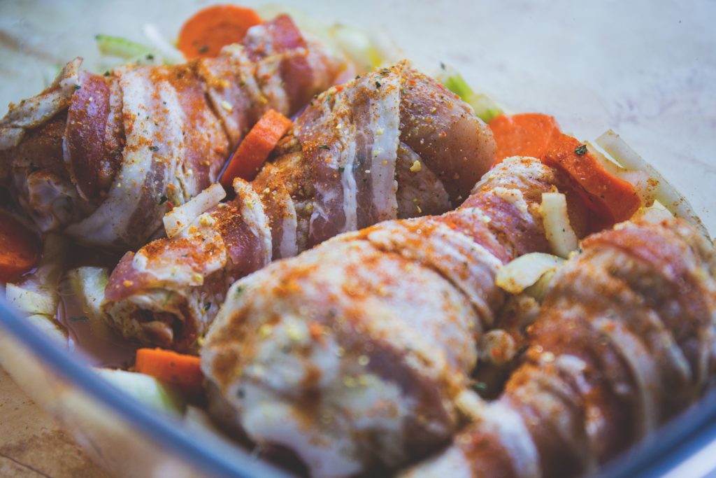 Raw chicken legs wrapped in bacon - free stock photo