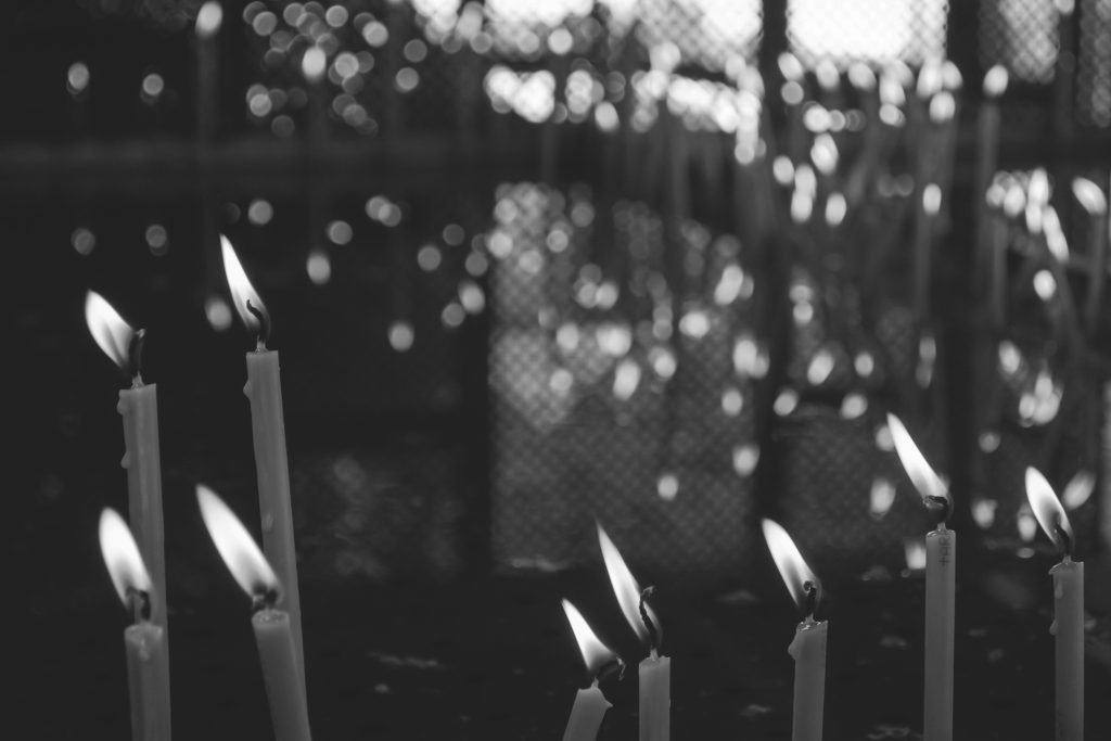 Votive candles in black and white - free stock photo