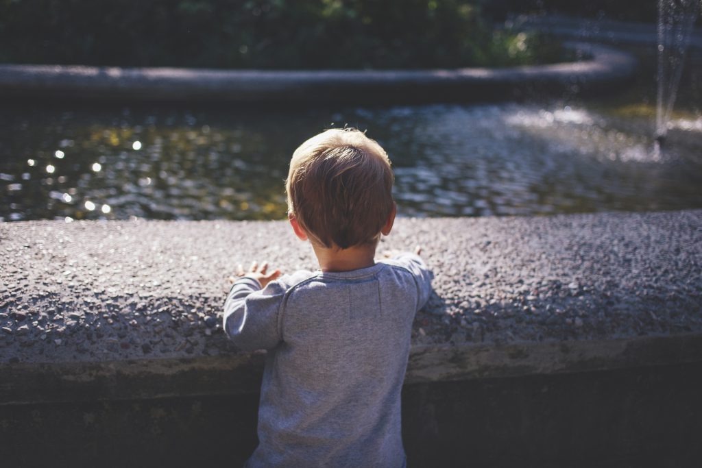 Boy at a fountain - free stock photo