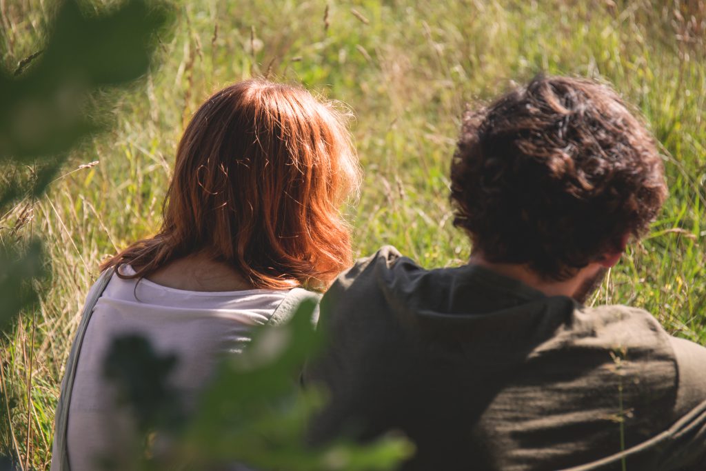 Couple sitting in the meadow 2 - free stock photo