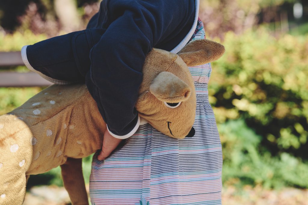 A girl holding plush Bambi - free stock photo