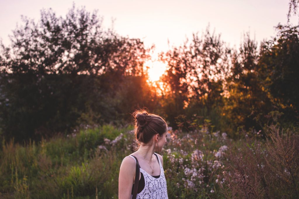 girl looking back at sunset