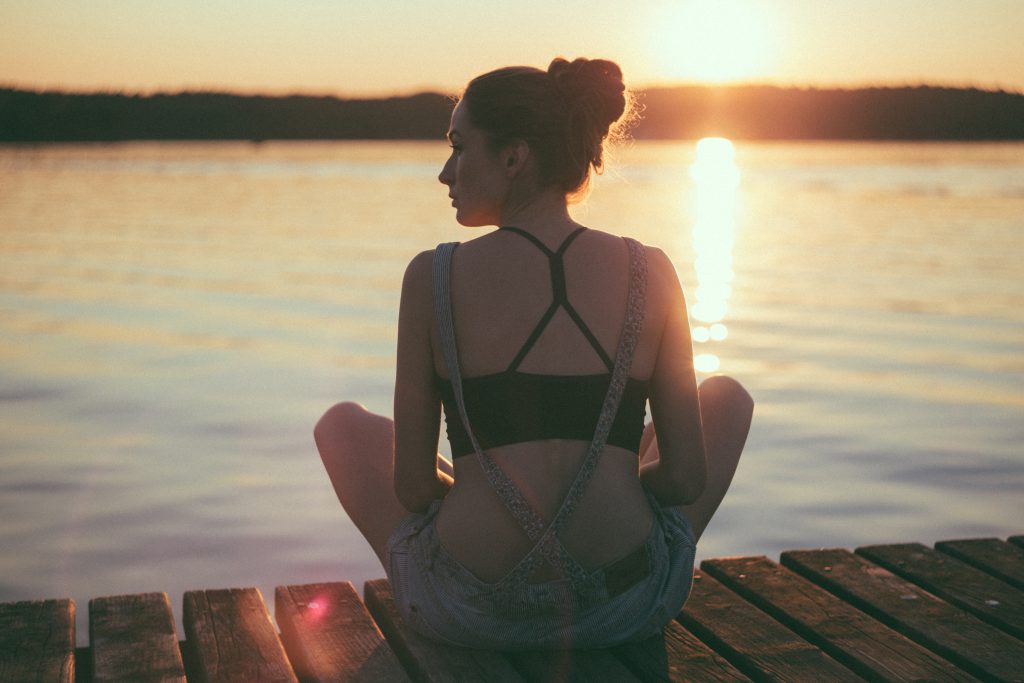 Girl sitting on a pier - free stock photo