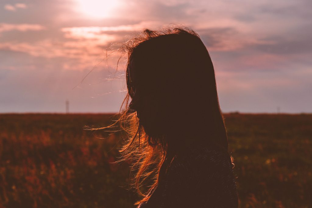 Girl’s head silhouette at sunset - free stock photo