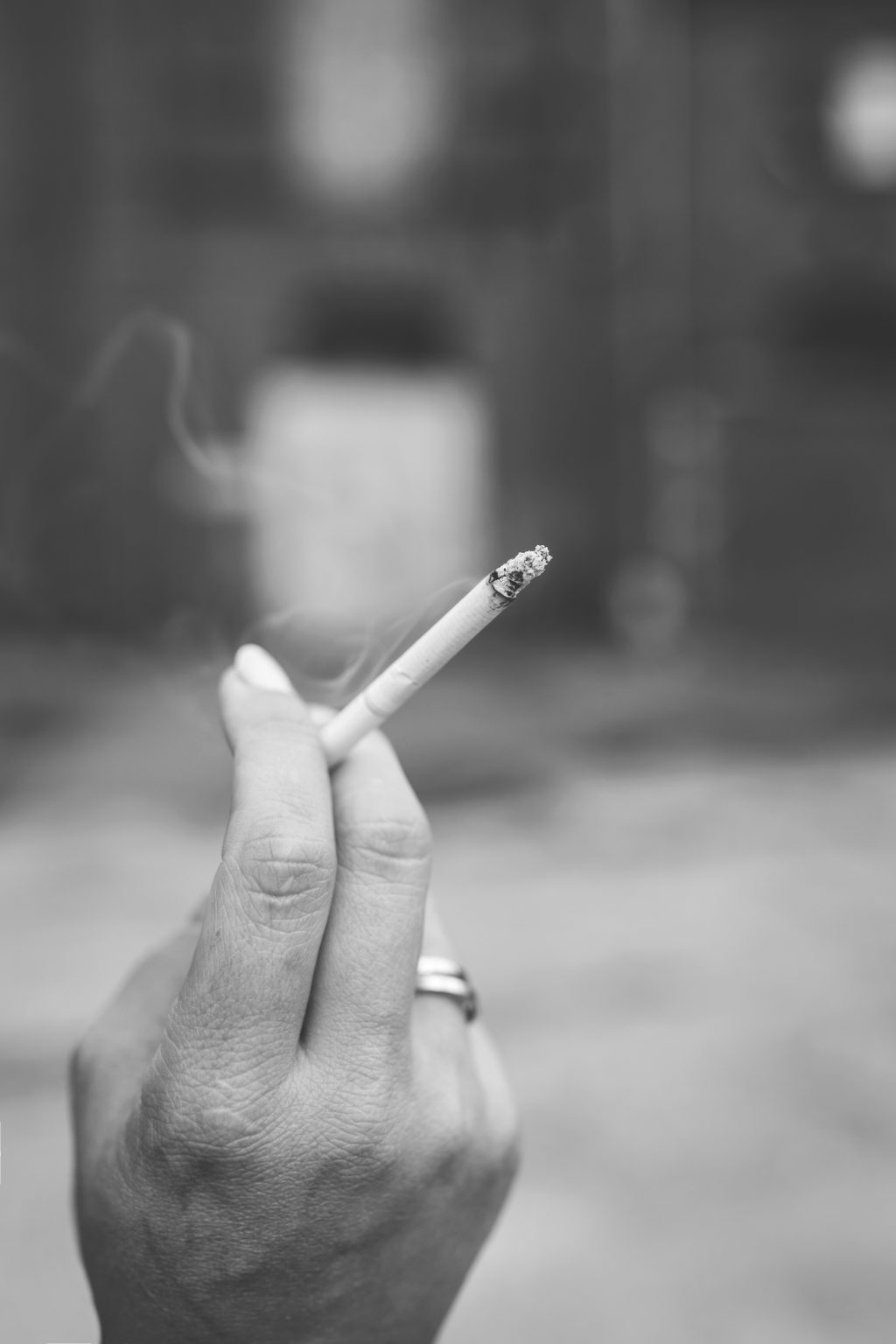 Hand holding a cigarette - free stock photo