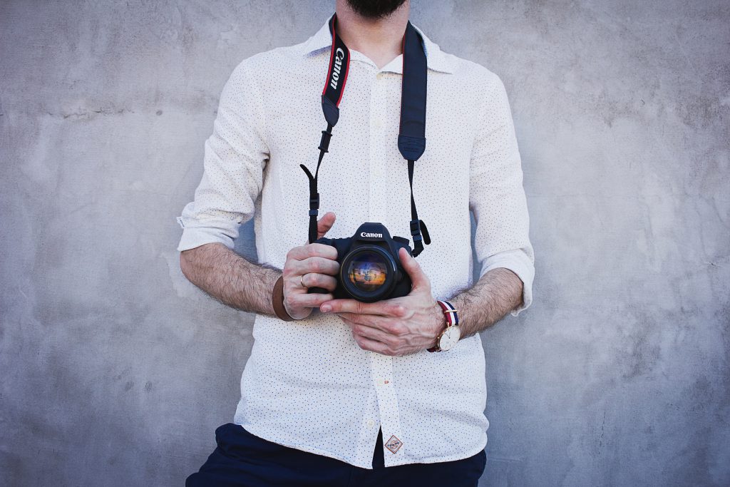 Man holding a camera - free stock photo