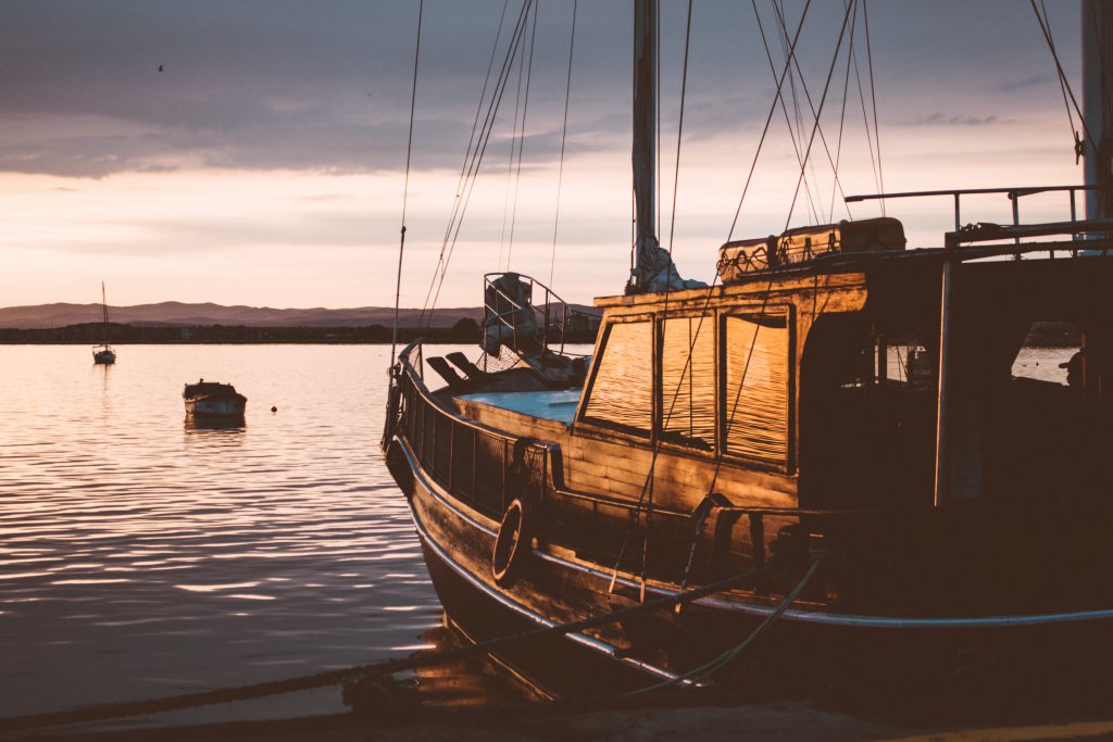 A sailing boat at sunset - free stock photo