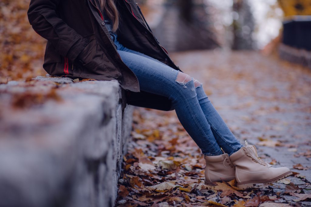 girl sitting on the park wall