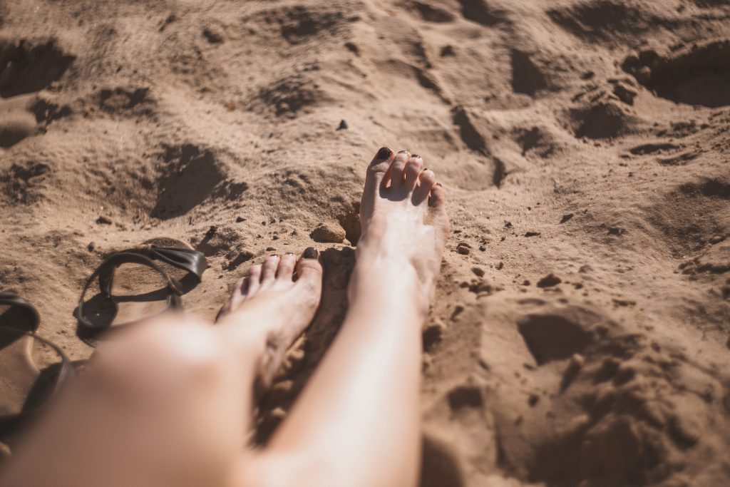 Legs in the sand - free stock photo