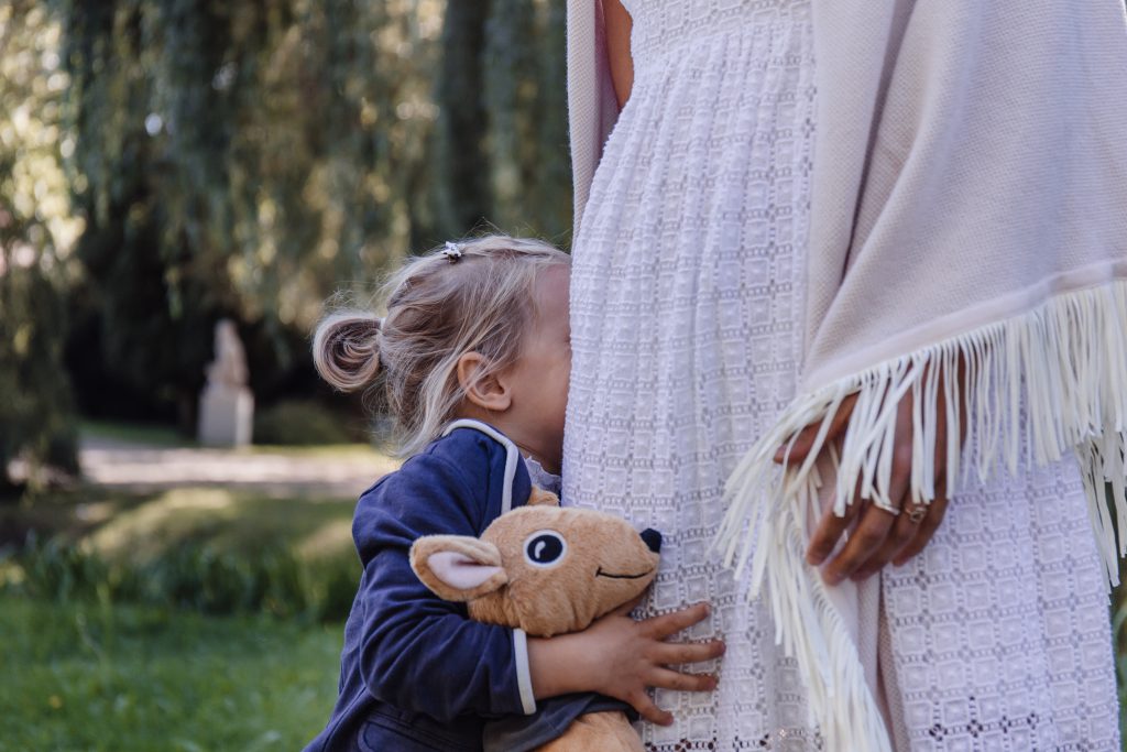 Shy little girl with her mom - free stock photo