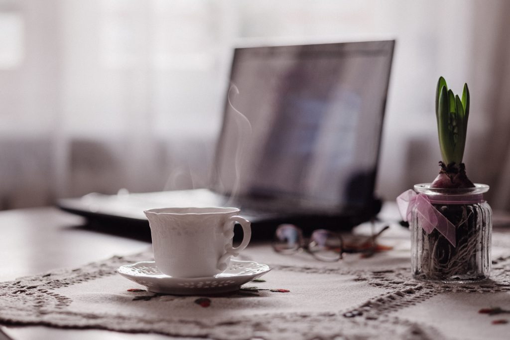 Cup of coffee, flower and laptop - free stock photo