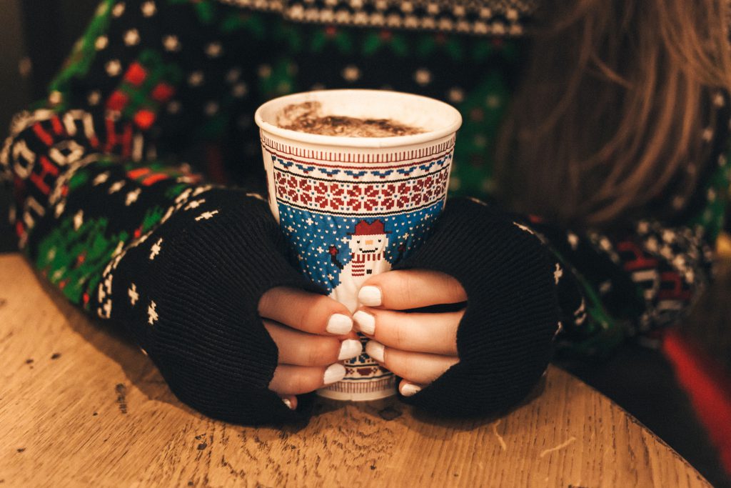 Girl holding christmas coffee cup - free stock photo