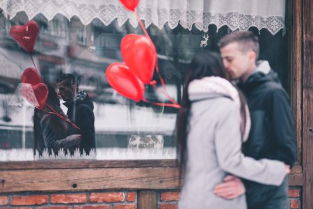 A couple with heart shape baloons - free stock photo