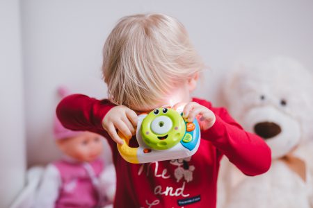 Little girl with a toy camera - free stock photo