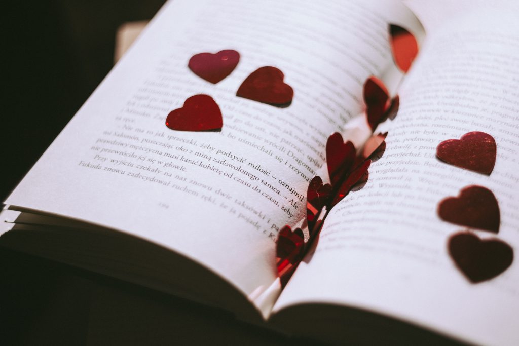 Heart confetti in an open book - free stock photo