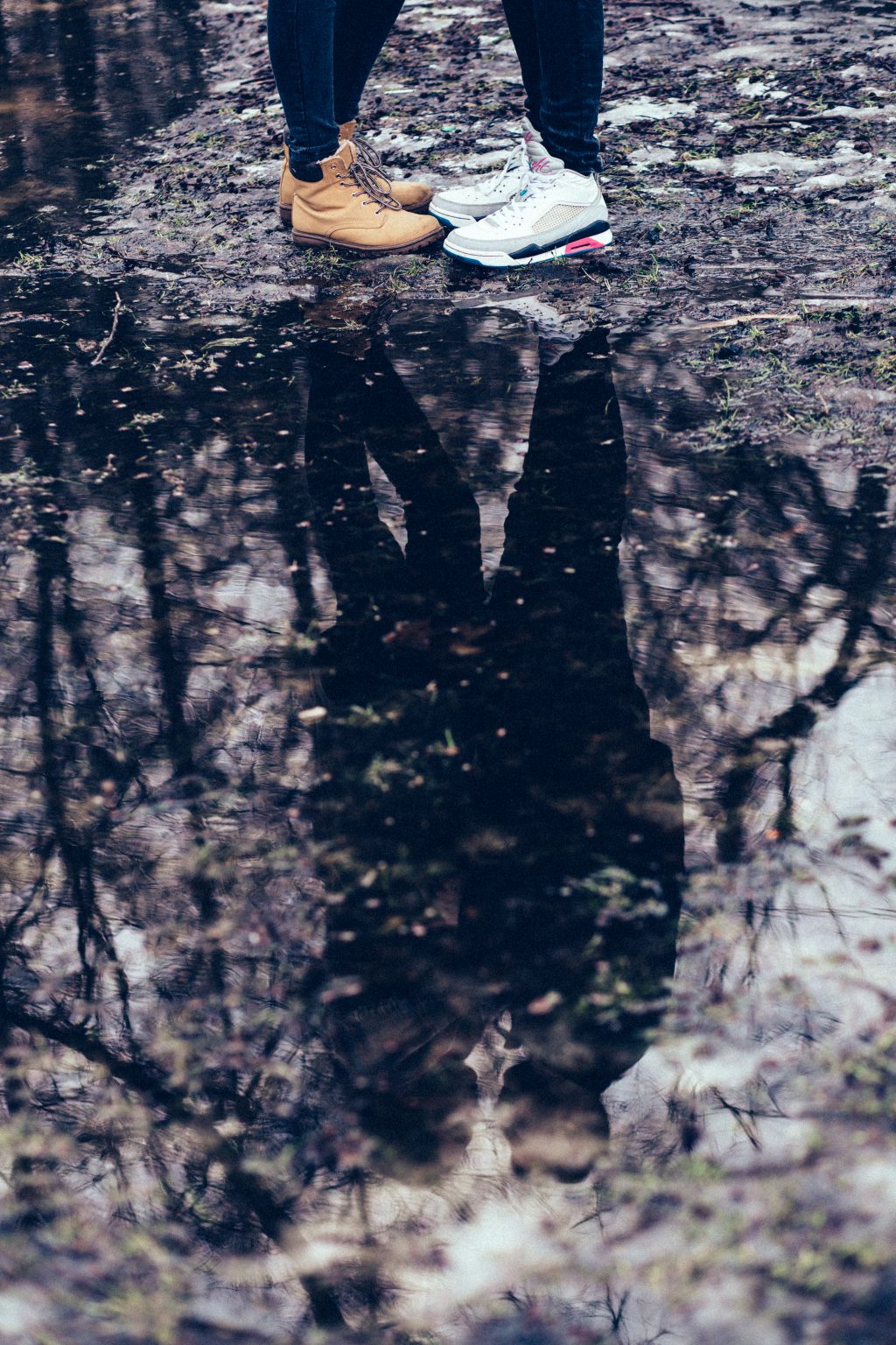 A couple reflection in a puddle - free stock photo