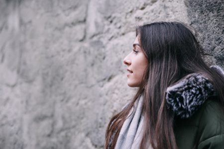 A girl leaning against a wall - free stock photo