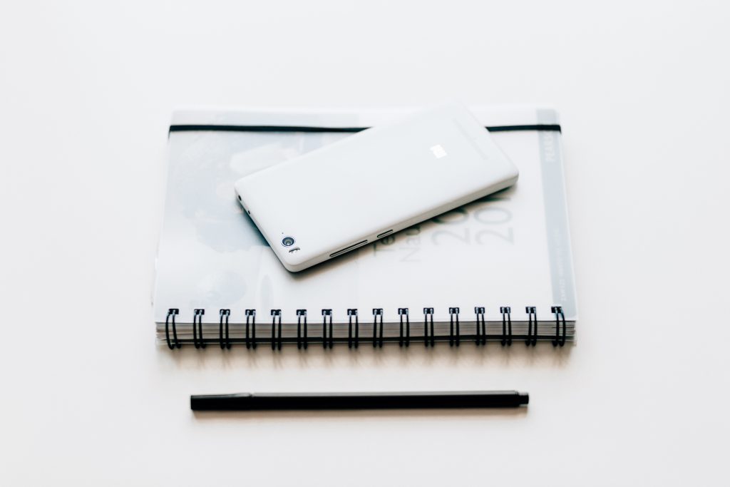 A planner and a phone - free stock photo