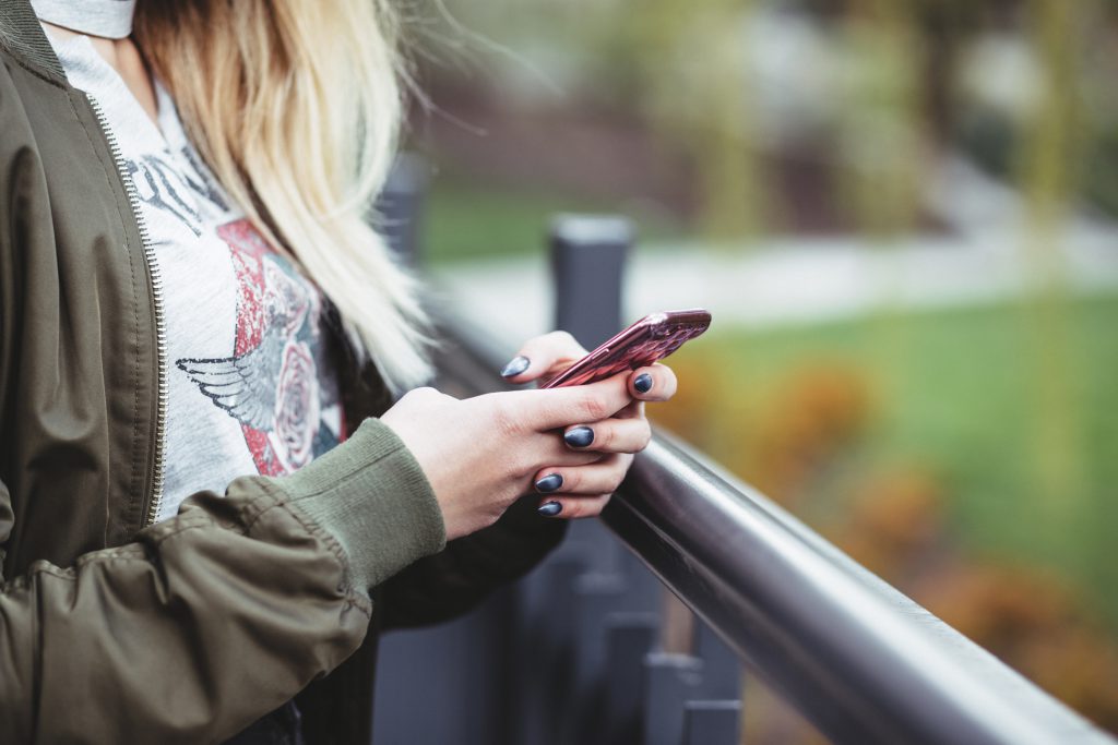 A girl using a phone - free stock photo