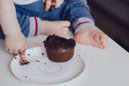 Baby eating a muffin - free stock photo