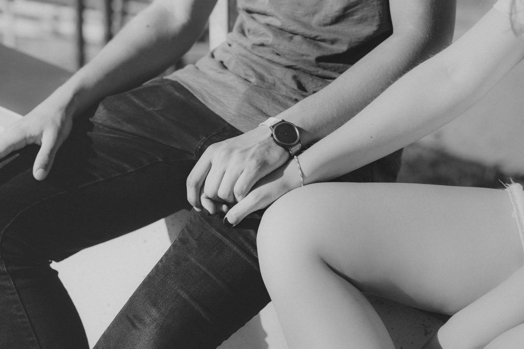 A couple holding hands in b&w - free stock photo