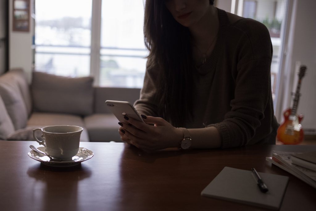 Female holding an iPhone 8 Plus - free stock photo