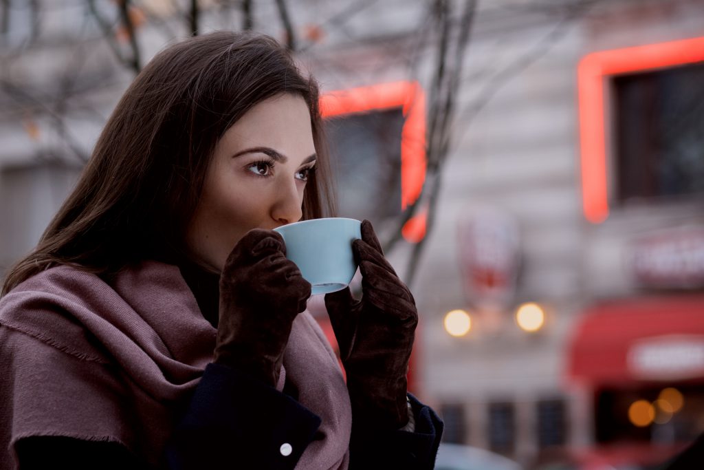 A woman drinking coffee outdoors 2 - free stock photo