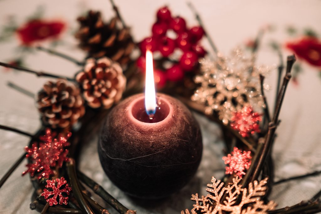 Christmas wreath and a round candle - free stock photo