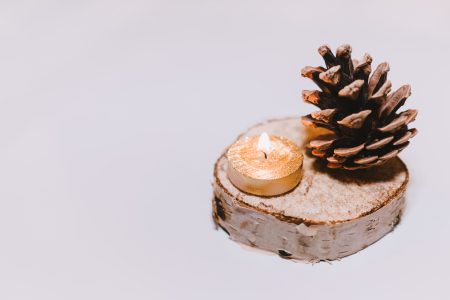 Gold tealight and a pinecone - free stock photo