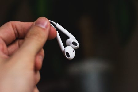 iPhone headphones in a male hand - free stock photo