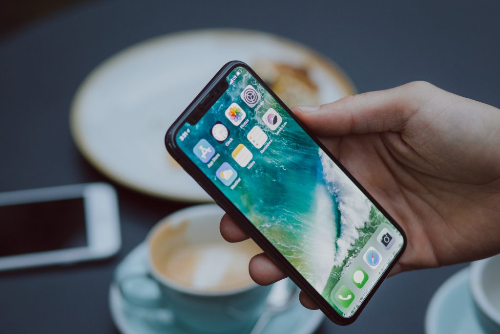 Male holding an iPhone X - free stock photo