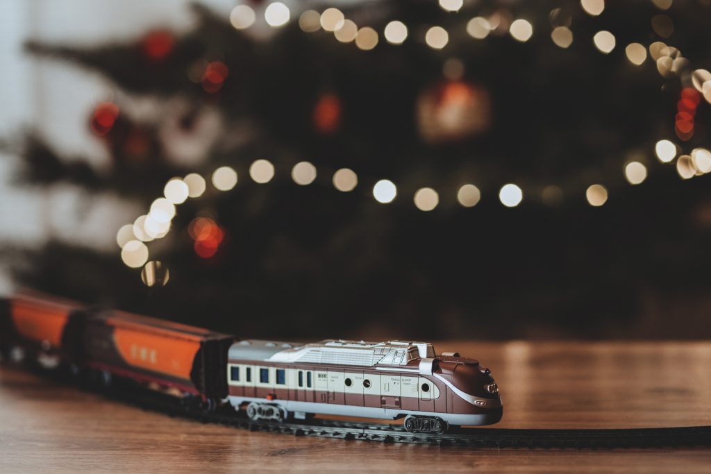 Toy train going around the Christmas tree - free stock photo