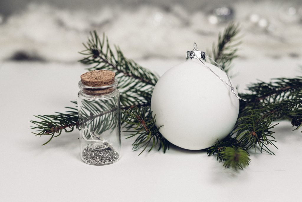 White and silver bauble with a spruce twig - free stock photo