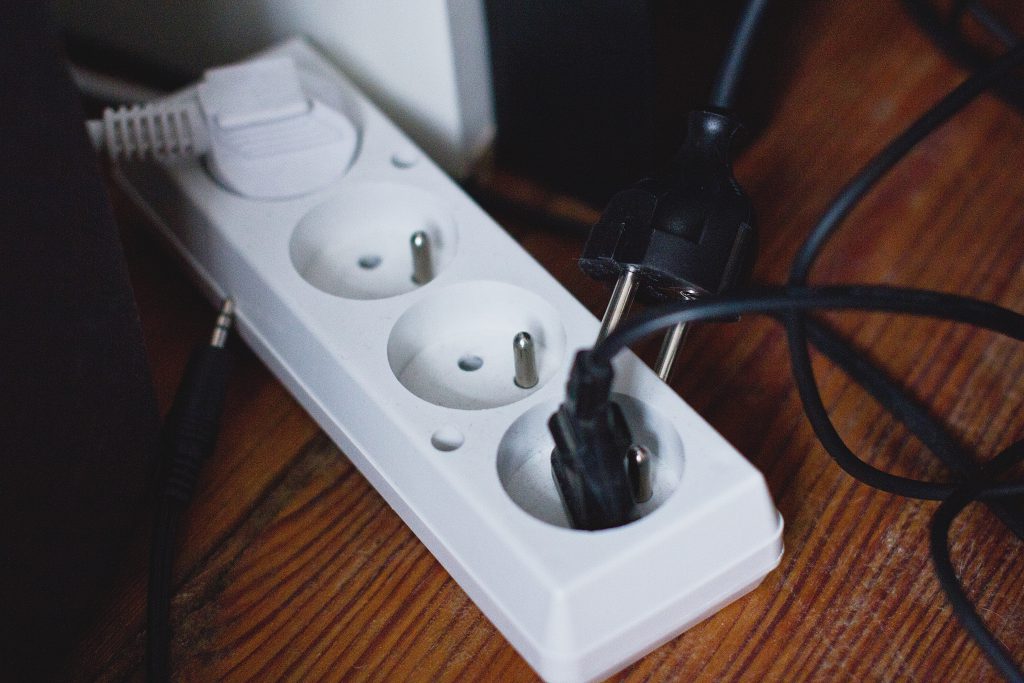 Computer cables plugged into an extension cord - free stock photo