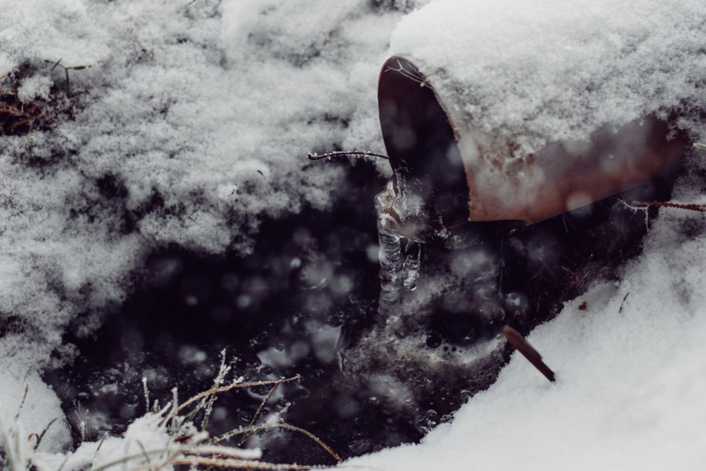 Icicles on a drainpipe - free stock photo