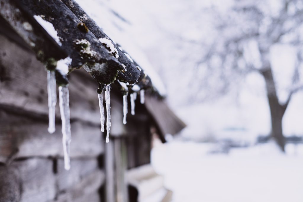 Icicles on a wooden shed - free stock photo