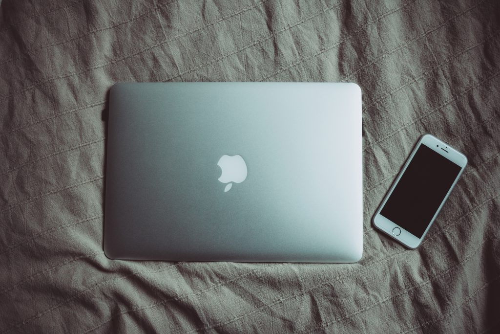 MacBook and iPhone on bed - free stock photo