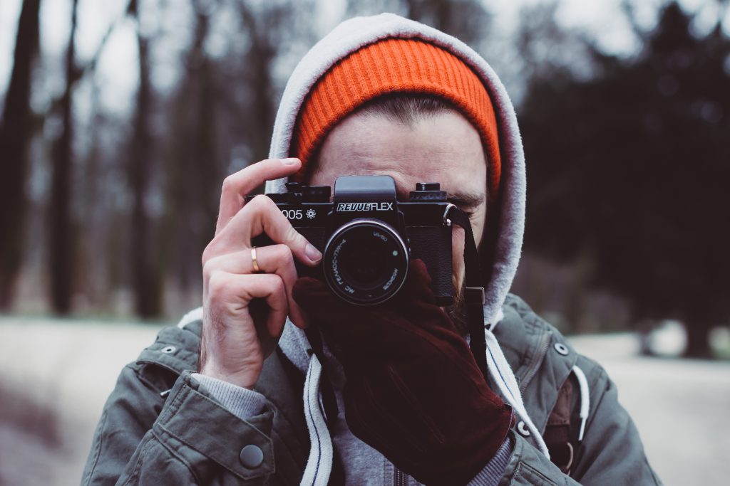 Man shooting with an analog camera - free stock photo