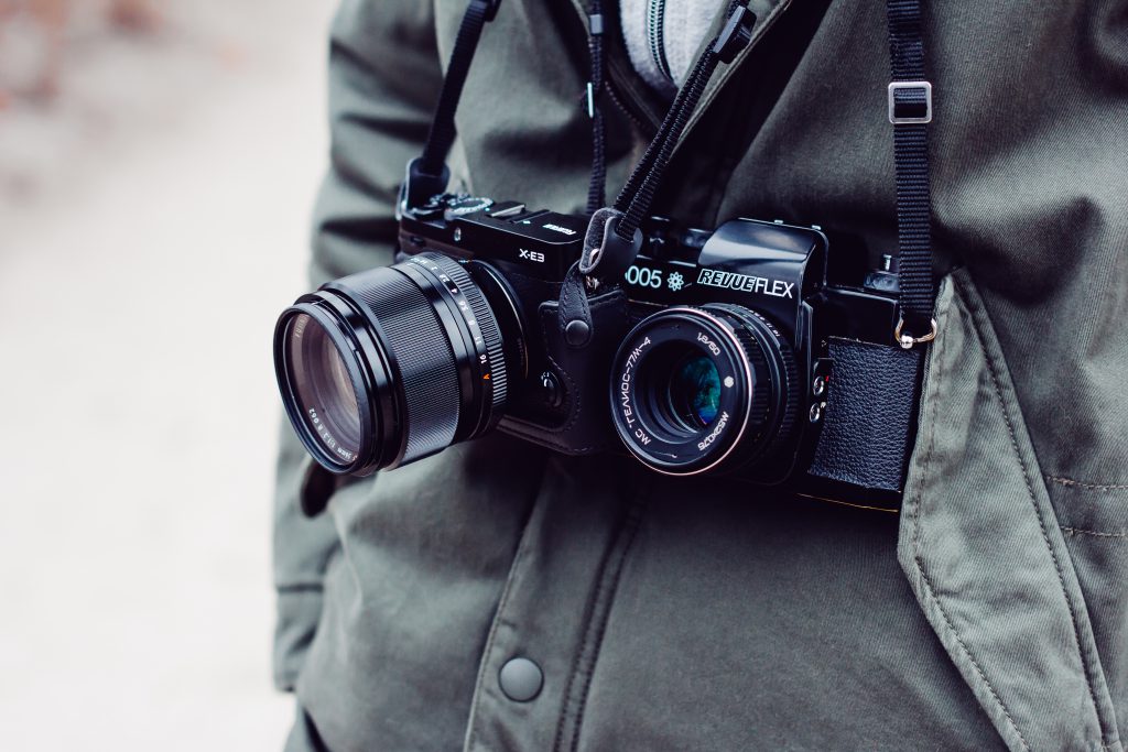 Man with two cameras over his neck - free stock photo