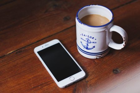 Oldschool mug of latte and an iPhone - free stock photo