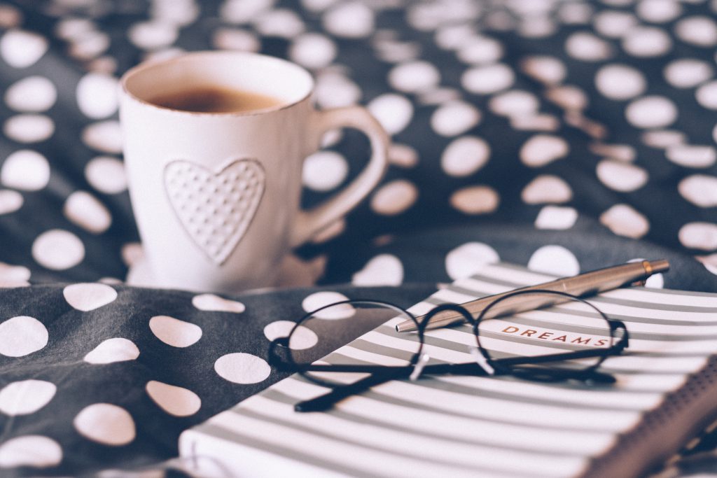 Coffee mug, notebook and glasses - free stock photo