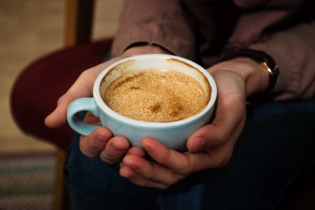 Cup of flat white in female hands - free stock photo