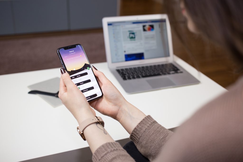 A female holding an iPhone X - free stock photo