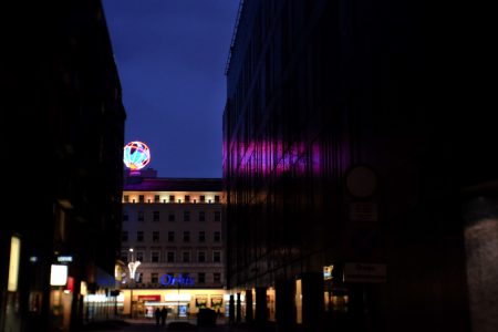 Illuminated led globe in the city at night - free stock photo